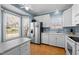 Bright kitchen featuring stainless steel appliances, white cabinetry, and ample counter space at 12 Citation Dr, Durham, NC 27713