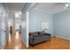 Inviting living room with hardwood floors, light blue walls, and comfortable gray couch at 12 Citation Dr, Durham, NC 27713