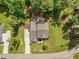 Aerial view of a home with a well-maintained lawn, driveway, and surrounding trees at 1328 Mill Glen Cir, Raleigh, NC 27614