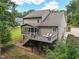 Expansive backyard view featuring a deck, screened-in porch, and a well-maintained lawn at 1328 Mill Glen Cir, Raleigh, NC 27614