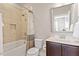 Bathroom featuring a tub, shower, toilet, dark wood vanity and large mirror at 1328 Mill Glen Cir, Raleigh, NC 27614