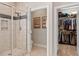 Tiled bathroom with glass-enclosed shower and a view into the walk-in closet at 1328 Mill Glen Cir, Raleigh, NC 27614