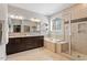 Spacious bathroom with dual vanity, soaking tub, and glass-enclosed shower at 1328 Mill Glen Cir, Raleigh, NC 27614