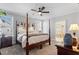 Cozy primary bedroom features a four-poster bed, ceiling fan, and ensuite bathroom at 1328 Mill Glen Cir, Raleigh, NC 27614