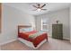 A comfy bedroom with a ceiling fan, a large window, a bed and dresser at 1328 Mill Glen Cir, Raleigh, NC 27614