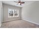 This cozy bedroom features a ceiling fan and a large window for natural light at 1328 Mill Glen Cir, Raleigh, NC 27614
