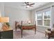 Cozy bedroom showcasing a bed, a window with curtains, and a sitting chair at 1328 Mill Glen Cir, Raleigh, NC 27614