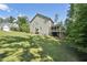 Lush backyard and exterior of a house featuring a screened porch and wooden deck at 1328 Mill Glen Cir, Raleigh, NC 27614