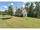 Two-story house with green lawn and mature trees in a tranquil residential neighborhood at 1328 Mill Glen Cir, Raleigh, NC 27614