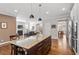 Open-concept kitchen with island seating, granite countertops, and stainless-steel appliances at 1328 Mill Glen Cir, Raleigh, NC 27614