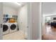 Bright laundry room featuring a washer, dryer, and built-in shelving at 1328 Mill Glen Cir, Raleigh, NC 27614