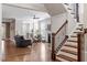 Inviting living room with a fireplace and hardwood floors, adjacent to staircase at 1328 Mill Glen Cir, Raleigh, NC 27614