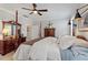Well-lit bedroom with a decorative ceiling fan, hardwood furniture, and modern lamps at 1328 Mill Glen Cir, Raleigh, NC 27614