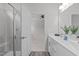 A bright bathroom featuring a double vanity, framed mirror, and glass-enclosed shower at 1329 Channing Park Cir, Cary, NC 27519