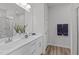 Bright bathroom featuring a double sink vanity, a large mirror, a stand-up shower, and wood plank flooring at 1329 Channing Park Cir, Cary, NC 27519