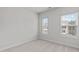 Neutral bedroom featuring two windows allowing ample natural light and an open, airy space at 1329 Channing Park Cir, Cary, NC 27519