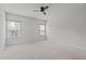 Large primary bedroom featuring two windows, a ceiling fan, and ample room, showcasing an airy ambiance at 1329 Channing Park Cir, Cary, NC 27519