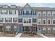 Charming townhomes with stone accents, colorful front doors, and coordinated shutters, offering a welcoming curb appeal at 1329 Channing Park Cir, Cary, NC 27519