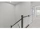 Bright hallway featuring a staircase with decorative railing and an open doorway to a bedroom at 1329 Channing Park Cir, Cary, NC 27519