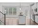 Modern kitchen with center island and an open floor plan to an adjacent living area at 1329 Channing Park Cir, Cary, NC 27519