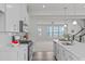 Open-concept kitchen with stainless steel appliances, white countertops, and seamless flow to the adjacent living area at 1329 Channing Park Cir, Cary, NC 27519