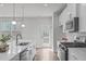 Inviting kitchen with stainless steel appliances, white cabinetry, and access to an outdoor deck for easy entertaining at 1329 Channing Park Cir, Cary, NC 27519