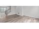 Bright living room features wood-look floors and staircase access to upper level at 1329 Channing Park Cir, Cary, NC 27519
