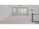 Large, sun-filled living area features neutral walls, plush carpet, and large windows at 1329 Channing Park Cir, Cary, NC 27519