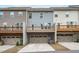 Exterior back view of townhomes, each with its own garage and deck at 1329 Channing Park Cir, Cary, NC 27519