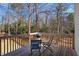 Back deck features wooden chairs, a grill, and scenic views at 15 Rocky Point Ct, Fuquay Varina, NC 27526
