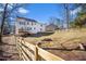 Spacious backyard and partial view of home exterior with a wooden fence at 15 Rocky Point Ct, Fuquay Varina, NC 27526