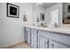 Bathroom featuring double vanity, large mirror, and cabinet storage at 15 Rocky Point Ct, Fuquay Varina, NC 27526