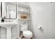 Bathroom features a sleek pedestal sink, modern fixtures, and ample natural light at 15 Rocky Point Ct, Fuquay Varina, NC 27526