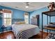 Bright bedroom with hardwood floors, large windows, and stylish furnishings at 15 Rocky Point Ct, Fuquay Varina, NC 27526