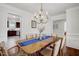 Formal dining area showcasing chandelier and open view to kitchen and living space at 15 Rocky Point Ct, Fuquay Varina, NC 27526