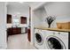 Well-equipped kitchen next to a laundry area with modern washer and dryer at 15 Rocky Point Ct, Fuquay Varina, NC 27526