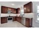 Updated kitchen featuring modern appliances, granite countertops, and ample cabinet space for storage and functionality at 15 Rocky Point Ct, Fuquay Varina, NC 27526
