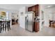 Open kitchen showcasing stainless steel refrigerator and seamless flow to dining and living areas at 15 Rocky Point Ct, Fuquay Varina, NC 27526