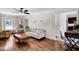 Cozy living room with natural light, stylish furniture, and seamless transition to the adjacent dining area at 15 Rocky Point Ct, Fuquay Varina, NC 27526