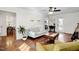 Bright living room with wood floors, neutral decor, and access to a dining area and back porch at 15 Rocky Point Ct, Fuquay Varina, NC 27526