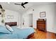 Bedroom with hardwood floors, white walls and ceiling, and classic wooden furniture at 15 Rocky Point Ct, Fuquay Varina, NC 27526