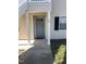 Inviting condo entrance with a gray front door, decorative windows, and well-kept landscaping at 151 Schultz St # 151, Chapel Hill, NC 27514