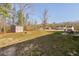 Large lot featuring a home with an outbuilding and a firepit in the backyard at 16 Eagle Swoop St, Zebulon, NC 27597