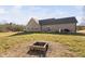 Spacious backyard with patio, seating, grill, and fire pit with view of the house at 16 Eagle Swoop St, Zebulon, NC 27597