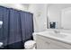 Clean bathroom with a toilet, vanity sink, and a shower with a blue curtain at 16 Eagle Swoop St, Zebulon, NC 27597