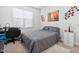 Bedroom with a bed, desk, and white dresser, decorated with art at 16 Eagle Swoop St, Zebulon, NC 27597