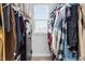 Walk-in closet filled with organized clothes and a window for natural light at 16 Eagle Swoop St, Zebulon, NC 27597