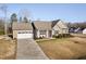 Well-maintained one-story home with an attached garage, long driveway, and manicured front lawn at 16 Eagle Swoop St, Zebulon, NC 27597