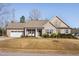 Charming single-story home with attached garage, landscaped yard, and inviting front porch at 16 Eagle Swoop St, Zebulon, NC 27597