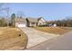 Single Gathering home with a well manicured lawn, long driveway, and attached two-car garage at 16 Eagle Swoop St, Zebulon, NC 27597